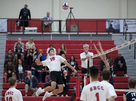 Freshman outside hitter Trent Lingruen flies high for a spike. He had 11 kills in his college debut. (Photo by Ken Sciallo/Sevilla Photography)