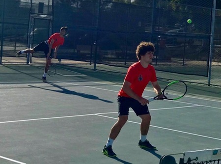 Albert Chami serves and Arthur Scharff patrols the net during their 8-5 triumph at No. 2 doubles.